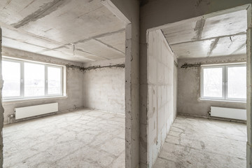 Empty interior for design, gray concrete wall. Empty room. Space for text and picture. Concrete walls, slabs, interior of a new residential building. Partitions in a new apartment.