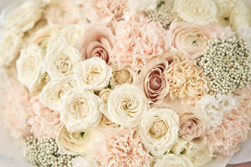 European floral shop. Beautiful bouquet of mixed flowers in womans hands. the work of the florist at a flower shop. Delivery fresh cut flower.