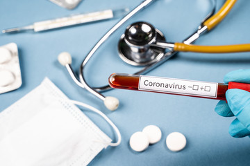 Hand holds test tube with blood for Coronavirus test