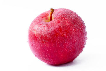 One red apple with water droplets on the skin on a white background