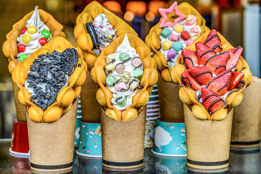 Chinese Hong Kong waffles with ice cream, jam and fruit. delicious bubble wafers in the old town of Bejing
