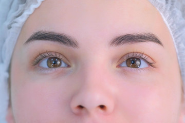 Woman's lashes before beauty procedure of eyelash lifting and laminating, closeup face view. Young...