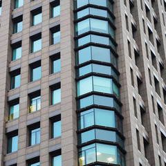 Texture of the facade of an office skyscraper. light in the windows of offices. Glass modern buildings. composition