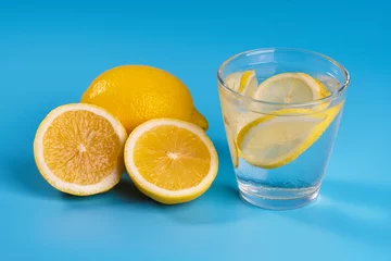 Foto op Plexiglas Lemonade with fresh lemons on blue background © mohdizuan