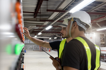 Electrical Engineer team working front HVAC control panels, Technician daily check controls system...