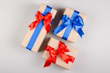 Gift box on gray background composition, present with ribbon and bow.