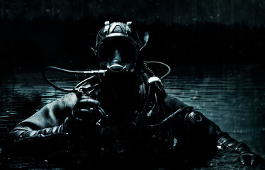 Military diver emerges from under the water. The concept of special military operations, wars,...