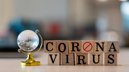 Concept Coronavirus. Prevent or stop the spread of the corona virus worldwide. Letters on the wooden floor resting on a wooden table. Tourists stop travel to travel from China. And related country. - obrazy, fototapety, plakaty