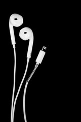 White earphones on a vertical black background