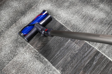 Vacuum cleaner on the floor. House cleaning concept. Before and after cleaning. Dirty and cleaned...
