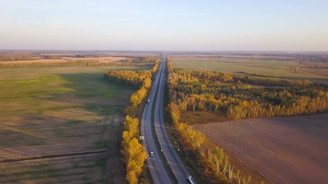 4K Aerial. Fly over highway with cars in rural area. Landscape