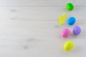 Multi-colored Easter eggs on a wooden table. Horizontal orientation, copy space.