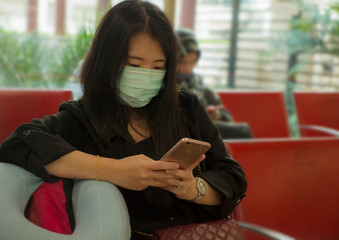 young beautiful tourist Asian Chinese tourist girl at airport wearing protective facial mask...