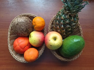 fruits in wooden baskets on wooden table