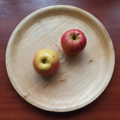 apples on wooden tray on wooden table