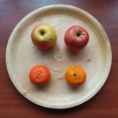 apples and mandarines on wooden tray on table