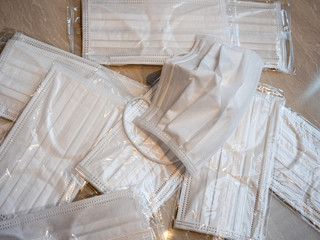A pile of white surgical masks used to prevent the spread of viruses
