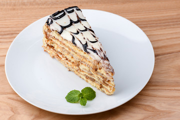 Esterhazy cake sliced on white plate. Sweet dessert with almond meringue dough and buttercream. Austrian cuisine.