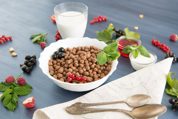 Healthy breakfast ingredients. Healthy tasty breakfast chocolate balls with strawberries, raspberries, black currants and red currants.