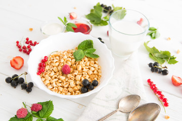 healthy breakfast with muesli and berry Healthy tasty breakfast of muesli with strawberries, raspberries, black currants and red currants.