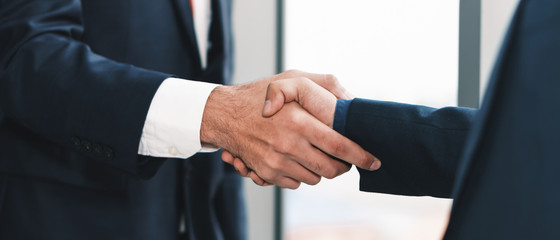 business background of businessman having handshaking after finish business deal