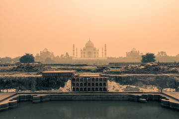 Wide shot of the backside of the Taj Mahal in Agra, India on overcast day with smog