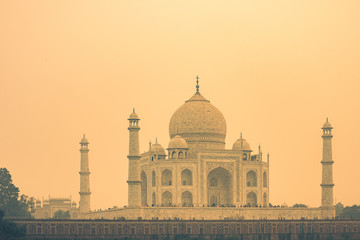 The backside of the Taj Mahal in Agra, India on overcast day with smog