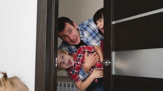 A Happy, Joyful Family Looks Out The Door.