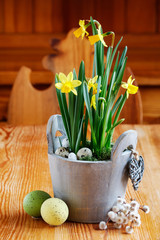 Beautiful spring flowers on wooden table. Traditional Easter decoration.