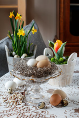 Sophisticated Easter decoration with eggs on crystal stand.