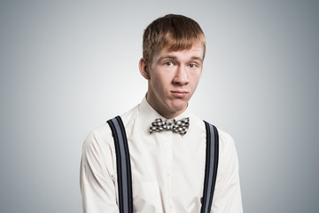 Sad young guy looking unsatisfied and upset