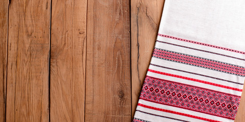 High resolution rustic wood background with traditional Ukrainian tablecloth. Copy space banner.
