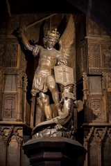 Obraz premium Statue of Saint Michel killing the dragoon in Saint Pierre parish church. Mont Saint Michel, France
