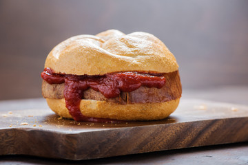 Bread roll with sausage and ketchup