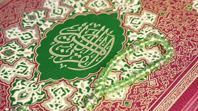 beads on top of Holy Quran , Shot of Holy Quran Muslims Holy Book Quran Kareem with a prayer rug and paternoster Tasbeeh - 4K