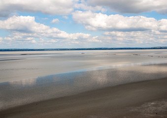 Fototapeta na wymiar Low tide in the bay in front of Mont Saint Michel in Normandy, France.