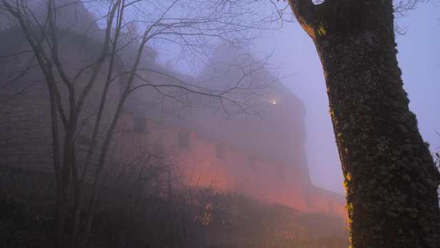 Silueta de castillo terror&iacute;fico de noche y con bruma y niebla azul y naranja