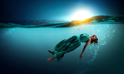 Woman dancer in clear blue water