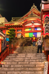 Buddhist Tokudaiji temple in the Ameyoko street of Tokyo at night.