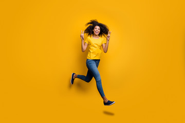 Fototapeta na wymiar Full length body size view of her she nice attractive lovely cheerful cheery carefree wavy-haired girl jumping showing v-sign having fun isolated on bright vivid shine vibrant yellow color background