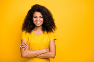 Close-up portrait of nice attractive lovely pretty charming intellectual cheerful cheery wavy-haired girl nerd folded arms isolated on bright vivid shine vibrant yellow color background