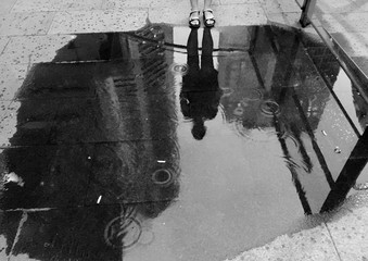 REFLECTION OF BUILDINGS IN PUDDLE