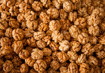 Closeup of big shelled walnuts pile. Walnuts close-up. Ripe and tasty peeled nuts big shelled walnuts pile.