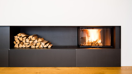 modern fireplace in the living room with space for storing wood