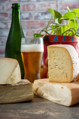 cheeses and Tomme de Savoie with beer, French cheese Savoy, french Alps France.