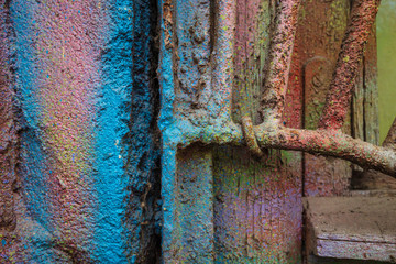 Part of the wall, window and metal grill in spots of paint