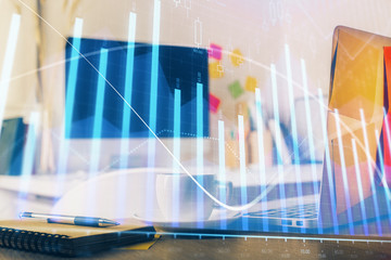 Stock market graph and table with computer background. Multi exposure. Concept of financial analysis.