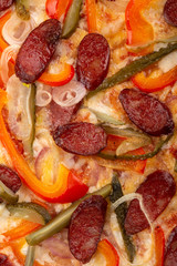 Delicious fresh pizza on table.  Delicious pizza. Large meat pizza with bacon, sausage, salami, pepperoni and olives. Homemade delicious italian pizza on wooden table for dinner. Italian cuisine.