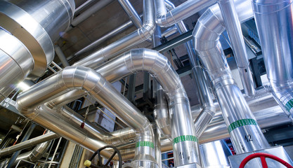 Equipment, cables and piping as found inside of a modern industrial power plant