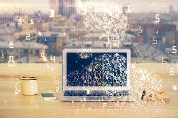 Computer on desktop in office with technology theme hologram. Multi exposure. Tech concept.